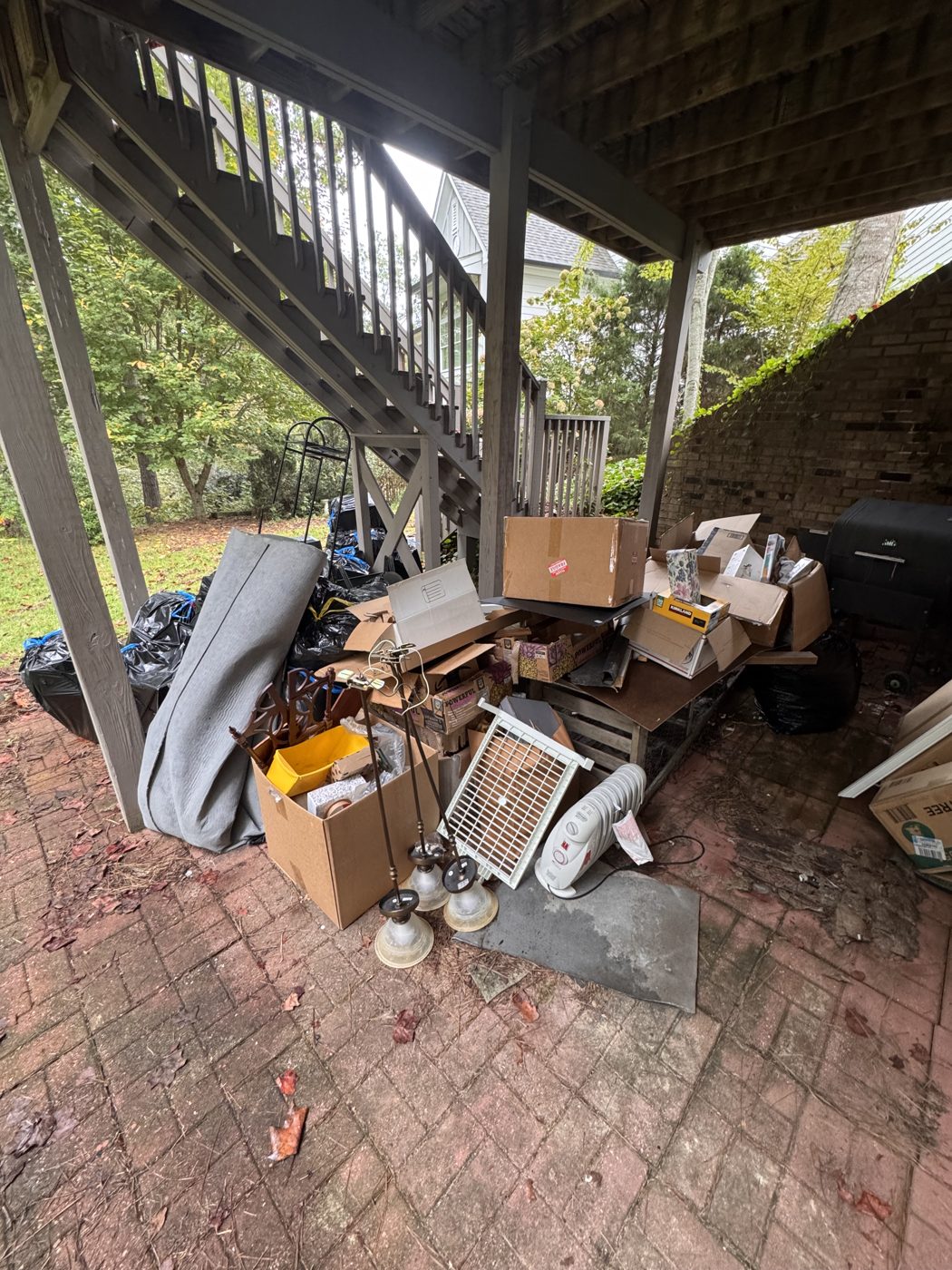 Before junk removal in Dawsonville, GA: under-deck cleanout