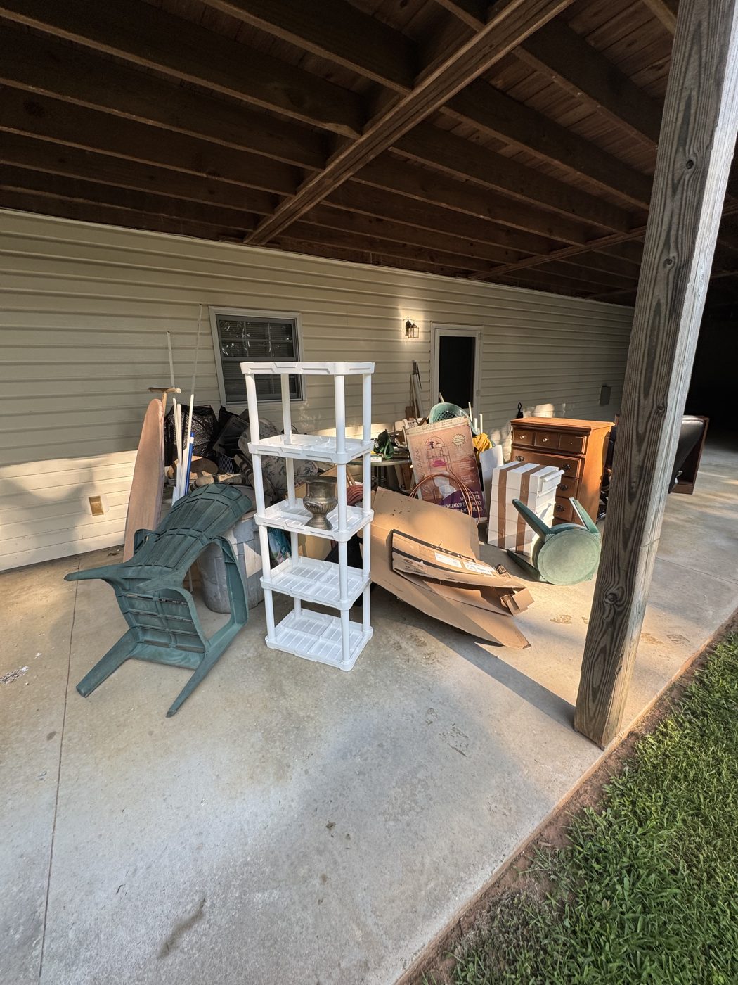 Before junk removal in Johns Creek, GA: covered patio cleanout